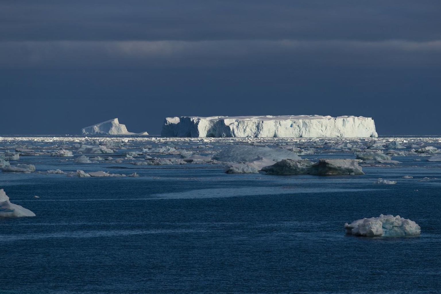 Sunlight hits an iceberg in the water on Thursday, March 7, 2019 in Crystal Sound, Antarctica. (Ric Tapia via AP)