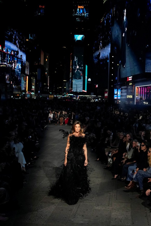 Cindy Crawford presents a creation from the Gucci Cruise 2027 collection at Times Square in New York City, U.S., May 16, 2026. REUTERS/Eduardo Munoz