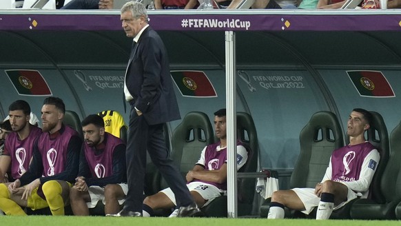 Portugal&#039;s Cristiano Ronaldo, right, sits on the bench during the World Cup group H soccer match between South Korea and Portugal, at the Education City Stadium in Al Rayyan , Qatar, Friday, Dec. ...