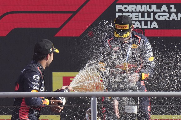 Second placed Red Bull driver Sergio Perez of Mexico, left, celebrates on the podium with winner Red Bull driver Max Verstappen of the Netherlands during the Formula One Italian Grand Prix auto race,  ...