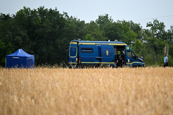 A French gendarme walks past a French Gendarmerie vehicle parked near the site where searches are conducted to find the body of Delphine Aussaguel, a 33-year-old nurse who went missing in France in De ...