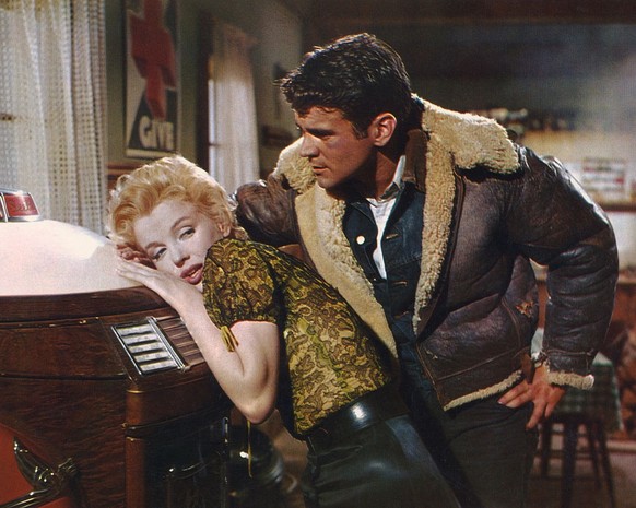 Marilyn Monroe leans against vintage jukebox as Don Murray stands over her in a scene from 'Bus Stop' 1956. (Photo by Screen Archives/Getty Images)