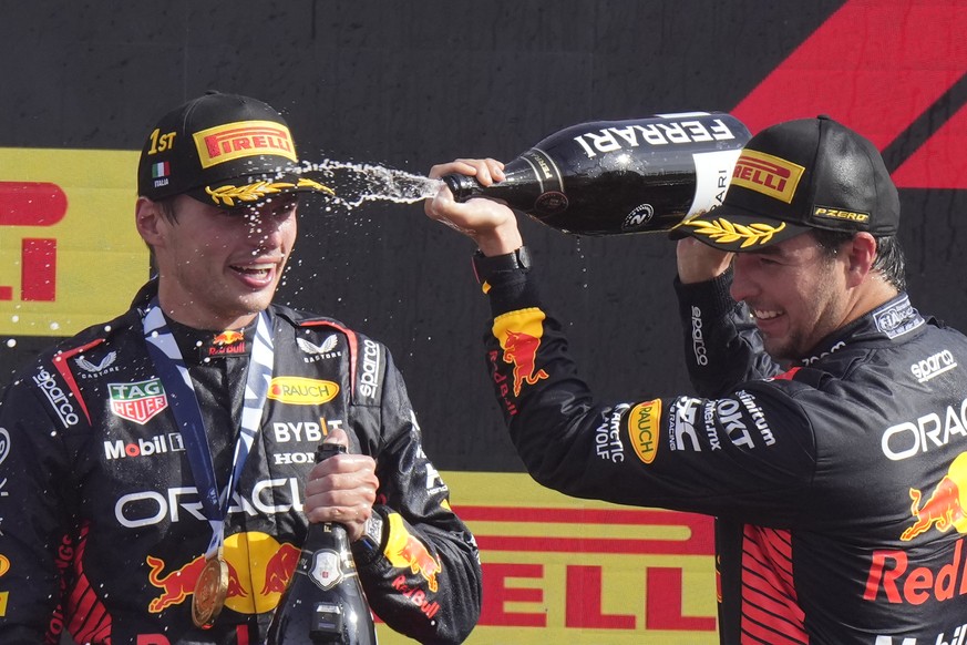Second placed Red Bull driver Sergio Perez of Mexico, right, celebrates on the podium with winner Red Bull driver Max Verstappen of the Netherlands after the Formula One Italian Grand Prix auto race,  ...
