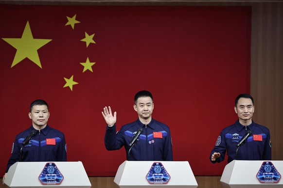 epa12048076 Austronauts of the Shenzhou-20 space mission (L-R) Wang Jie, Chen Dong and Chen Zhongrui, attend a press conference at the Jiuquan Satellite Launch Center near Jiuquan, China, 23 April 202 ...