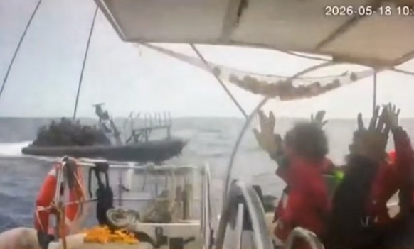 This grab from CCTV footage shows activists aboard a flotilla boat with their hands in the air as a boat approaches one of more than 50 vessels that departed from the port of Marmaris, Turkey, last we ...