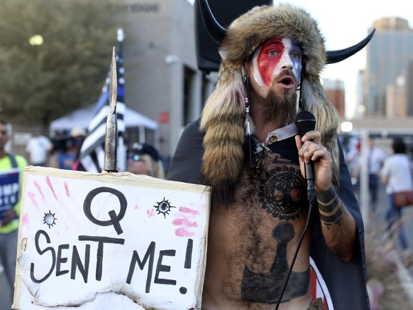 FILE - In this Nov. 5, 2020, file photo, Jacob Anthony Chansley, who also goes by the name Jake Angeli, a Qanon believer speaks to a crowd of President Donald Trump supporters outside of the Maricopa  ...