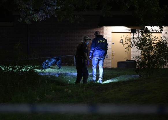 epa10886635 Police officers investigate the scene where a young man was shot at a sports ground in southern Stockholm, Sweden, 27 September 2023. The cause is still unknown and the suspect is still at ...