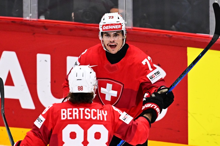 epa12132018 Switzerland&#039;s Sandro Schmid (R) celebrates after scoring the 5-0 during the IIHF Ice Hockey World Championship semifinal match between Switzerland and Denmark at Avicii Arena in Stock ...