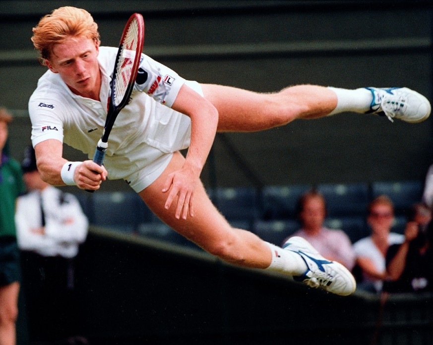 FILE - Defending champion Boris Becker of Germany flies through the air to return a shot from Australia&#039;s Wally Masur during their second round match at Wimbledon on Wednesday, June 27, 1990. Cau ...