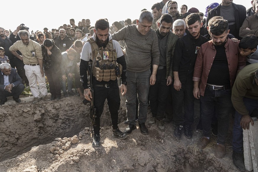 Syrian Kurds attend a funeral of people killed in Turkish airstrikes in the village of Al Malikiyah , northern Syria, Monday, Nov. 21, 2022. The airstrikes, which Turkey said were aimed at Kurdish mil ...