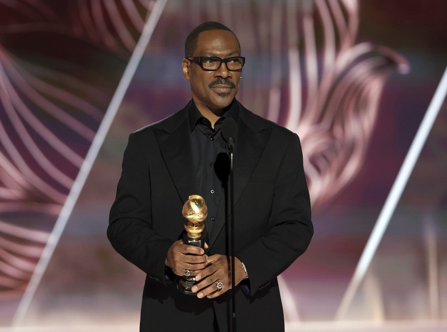 This image released by NBC shows Eddie Murphy accepting the Cecil B. DeMille Award during the 80th Annual Golden Globe Awards at the Beverly Hilton Hotel on Tuesday, Jan. 10, 2023, in Beverly Hills, C ...