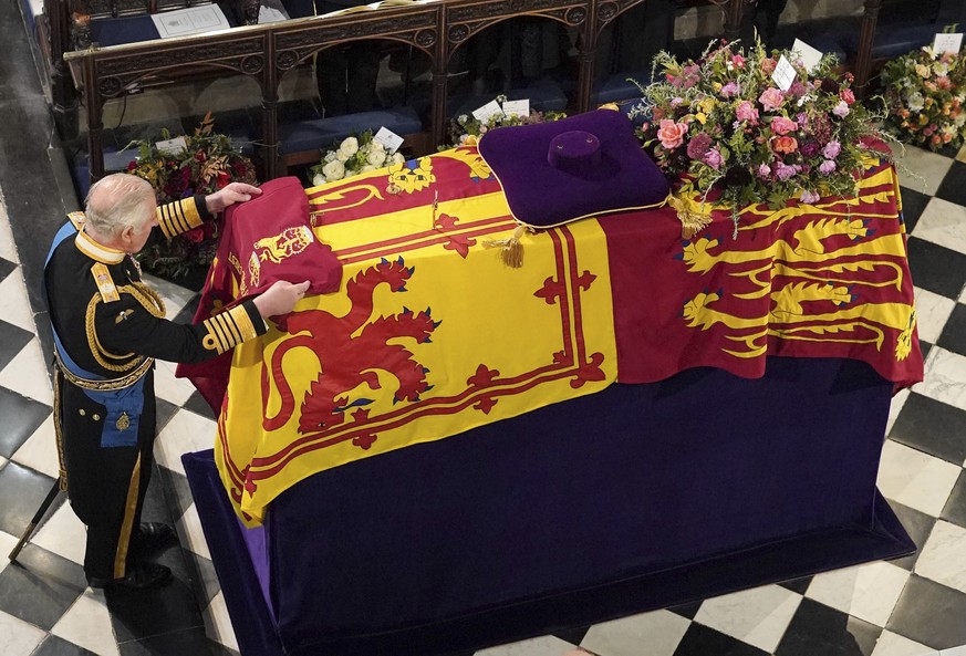 King Charles III places the Queen&#039;s Company Camp Colour of the Grenadier Guards on the coffin at the Committal Service for Queen Elizabeth II, held at St George&#039;s Chapel in Windsor Castle, M ...