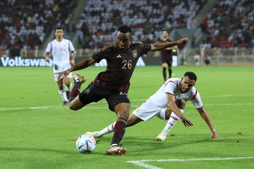MUSCAT, OMAN - NOVEMBER 16: Youssoufa Moukoko of Germany battles for the ball with Juma Al-Habsi of Oman during the international friendly match between Germany and Oman at Sultan Qaboos Sports Comple ...