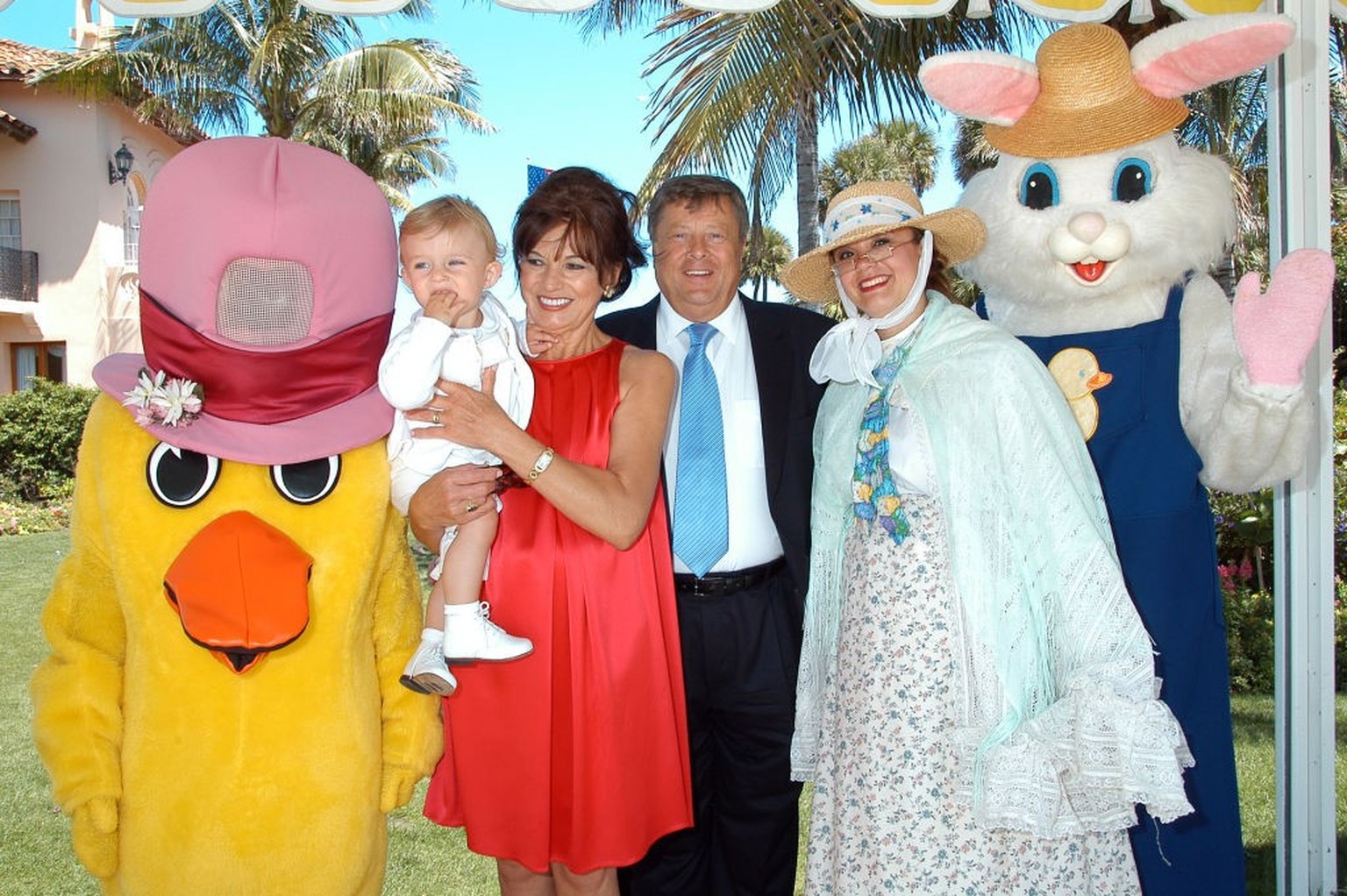 Barron Trump, second from left, is held by grandmother Amalija Knavs who stands next to husband Viktor Knavs during Easter Sunday events at the Mar-a-Lago club in Palm Beach, Florida, April 8, 2007. T ...