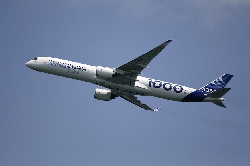 An Airbus A350-1000 aircraft participates in a fly-by during the Singapore Airshow 2022 at Changi Exhibition Centre in Singapore, Tuesday, Feb. 15, 2022. (AP Photo/Suhaimi Abdullah)