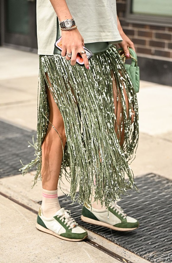 BERLIN, GERMANY - DECEMBER 10: Sonia Lyson is seen wearing black, oval-shaped Vehla sunglasses. Her outfit is cream-colored, consisting of a long, oversized faux fur coat that reaches her ankles. Unde ...
