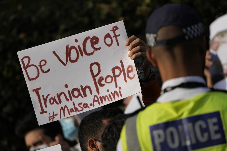 Demonstrators hold placards outside the Iranian Embassy in London, Sunday, Sept. 25, 2022. They were protesting against the death of Iranian Mahsa Amini, a 22-year-old woman who died in Iran while in  ...