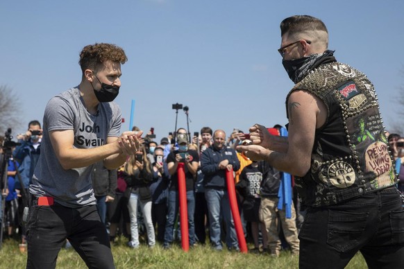 Josh Swain, left, the originator of the joke, takes on another Josh as they decide the rightful owner of the name Josh via a game of rock, paper, scissors in an open green space in Air Park on Saturda ...