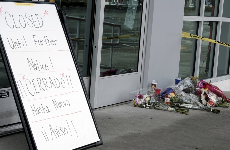 A votive candle and flowers are left for a teen who was fatally shot at a department store in the North Holywood section of Los Angeles on Saturday, Dec. 25, 2021. The coroner&#039;s office has identi ...