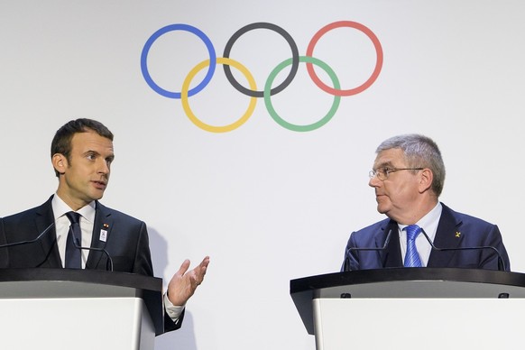 French President Emmanuel Macron, left, speaks with International Olympic Committee, IOC, President Thomas Bach, right, from Germany, during a visit of the Paris 2024 Candidate City delegation, at the ...