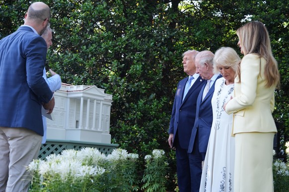 President Donald Trump and first lady Melania Trump along with Britain's King Charles III and Queen Camilla look at the garden and bee hive on the South Lawn of the White House, Monday, April 27, ...