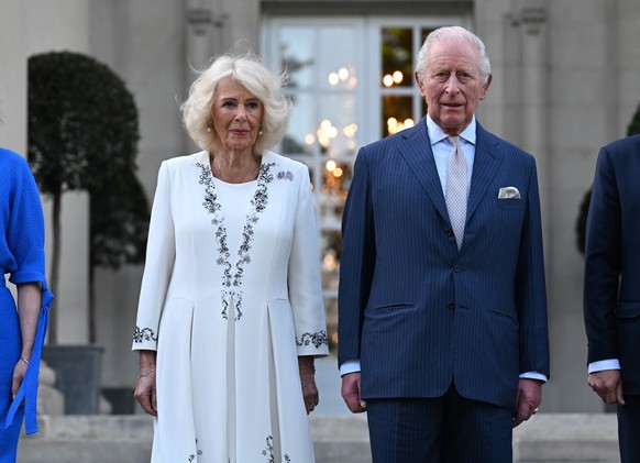 Britain's King Charles III and Queen Camilla arrive at a garden party at the British Embassy, Monday, April 27, 2026, in Washington. (Roberto Schmidt/Pool via AP)