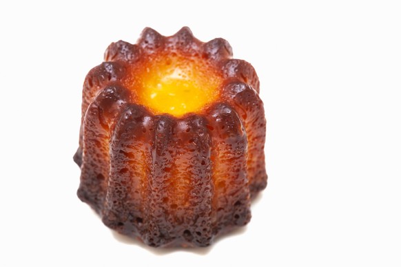 A canelé is a traditional French dessert pastry with a custard center and caramelized outer crust. It is believed to have originated in Bordeaux, France.