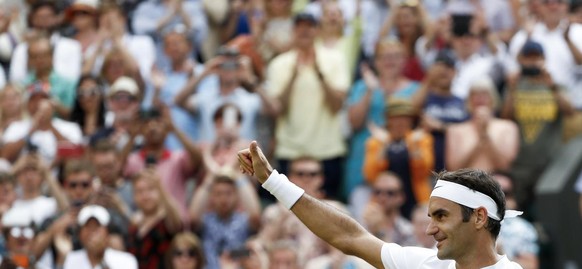 Roger Federer of Switzerland celebrates after beating Grigor Dimitrov of Bulgaria in their Men&#039;s Singles match, at the Wimbledon Championships at the All England Lawn Tennis Club, in London, Brit ...