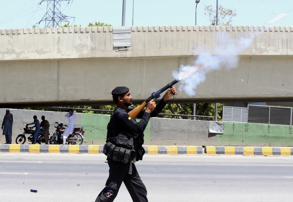A police officer fires tear gas to disperse supporters of Pakistan&#039;s former Prime Minister Imran Khan protesting against the arrest of their leader, in Peshawar, Pakistan, Wednesday, May 10, 2023 ...
