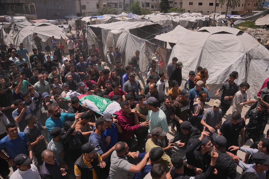 Palestinians carry the body of Izz al-Din al-Haddad, the leader of Hamas' Qassam Brigades, who was killed in an Israeli strike, during his funeral in Gaza City, Saturday, May 16, 2026. (AP Photo/ ...