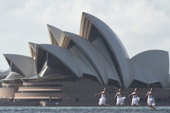 epa04624825 (L-R) Jade Wood, Jess Fyfe, Eli Fryer and Sharni Spencer from the Australian Ballet perform scenes from Swan Lake lake against the backdrop of the Sydney Harbour Bridge and the Sydney Oper ...