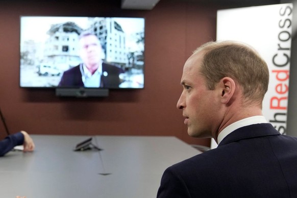 LONDON, ENGLAND - FEBRUARY 20: Prince William, The Prince of Wales, listens to Pascal Hundt, Senior Crisis Manager, International Committee of the Red Cross, dialling in from Gaza, during a visits of  ...