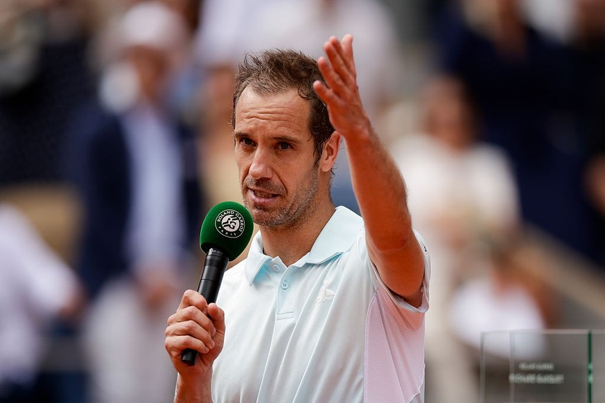 PARIS, FRANCE - MAY 29: Richard Gasquet of France speaks after being awarded a commemorative Trophy by Tournament Director Amelie Mauresmo following his final match during the 2025 French Open Day 5 a ...