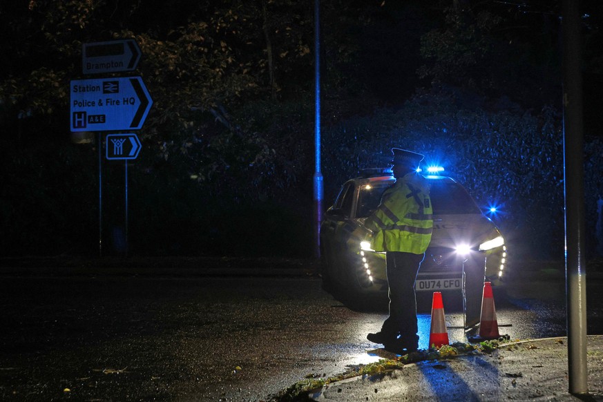 Police stand guard near the Huntingdon, England, train station in Cambridgeshire, after people were stabbed on a train, Saturday, Nov. 1, 2025. (Chris Radburn/PA via AP)
Britain-Train-Stabbings
