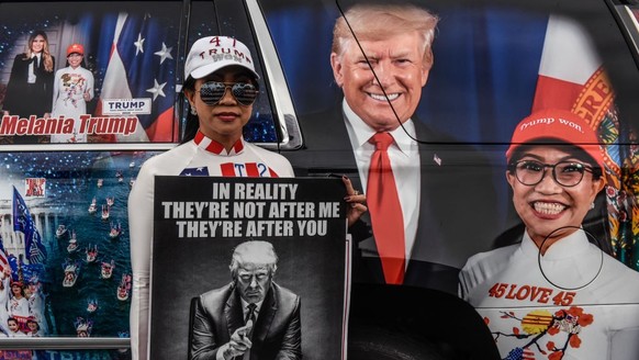 MIAMI, FLORIDA - JUNE 12: A supporter of former U.S. President Donald Trump poses for a photo outside of the Trump National Doral resort on June 12, 2023 in Miami, Florida. Trump is scheduled to appea ...