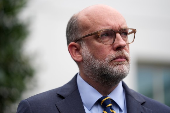 Russell Vought, Office of Management and Budget director, listens as he addresses members of the media outside the West Wing at the White House in Washington, Monday, Sept. 29, 2025, in Washington. (A ...