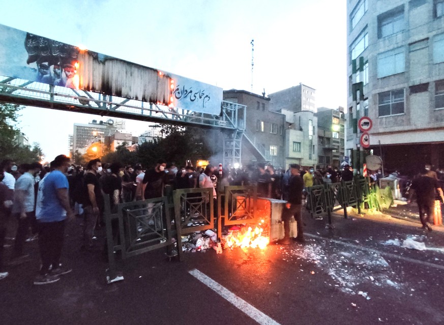 epa10197705 People clash with police during a protest following the death of Mahsa Amini, in Tehran, Iran, 21 September 2022. Mahsa Amini, a 22-year-old Iranian woman, was arrested in Tehran on 13 Sep ...