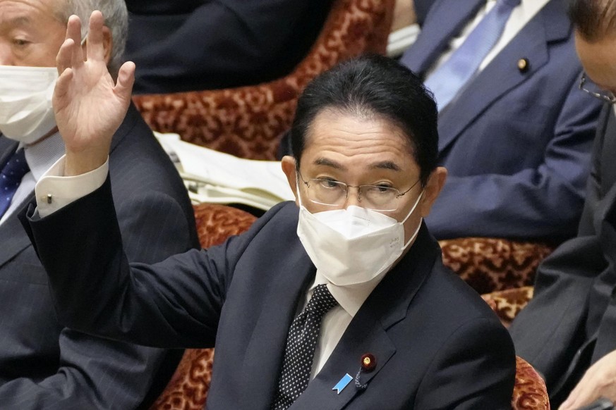 Japan���s Prime Minister Fumio Kishida raises a hand at a meeting of the Lower House Budget Committee in Tokyo Monday, Oct. 17, 2022. Kishida on Monday ordered an investigation into the Unification Ch ...