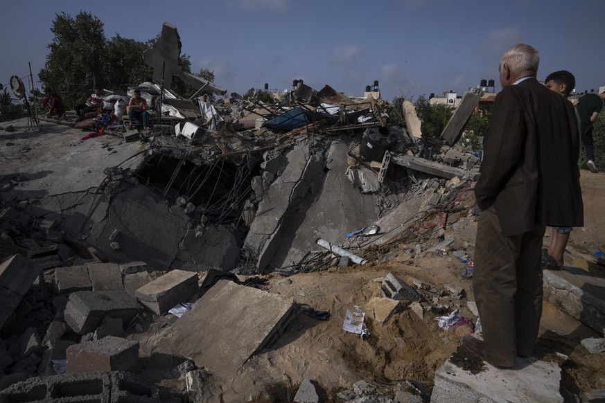 Palestinians inspect the rubble of a house after it was struck by an Israeli airstrike in Beit Lahia, northern Gaza Strip, Friday, May 12, 2023. On the fourth day of fighting between Israel and Islami ...
