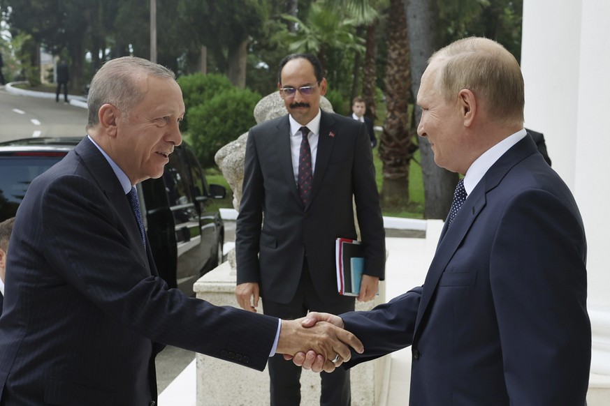 In this photo provided by the Turkish Presidency, Russian President Vladimir Putin, right, welcomes Turkish President Recep Tayyip Erdogan prior to their meeting at the Rus Sanatorium in the Black Sea ...