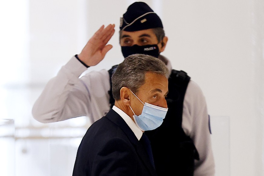 epa09044778 Former French president Nicolas Sarkozy (front) leaves court after the judgment on his trial on corruption charges in the so-called &#039;wiretapping affair&#039; in Paris, France, 01 Marc ...