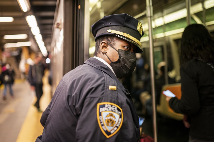 NYPD officers patrol platforms and train cars at the 36th Street subway station where a shooting attack occurred the previous day during the morning commute, Wednesday, April 13, 2022, in New York. Ma ...