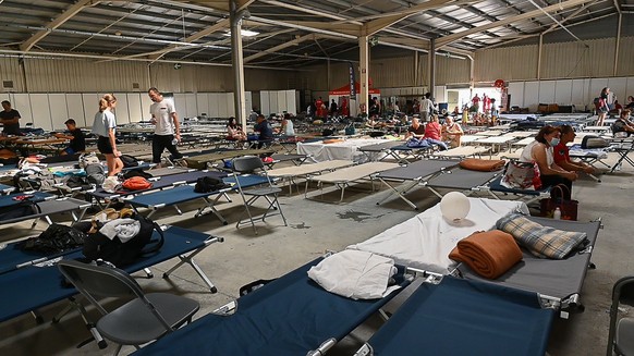epa10071185 People at the fire rescue center at La Teste de Buch, France, 14 July 2022. Nearby, in Cazaux, the evacuation of the town, air base and campsites was ordered. These evacuations are in addi ...