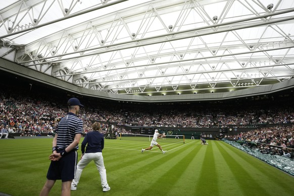 Britain&#039;s Ryan Peniston plays a return to Britain&#039;s Andy Murray under the Centre Court roof during a first round men&#039;s singles match on day two of the Wimbledon tennis championships in  ...