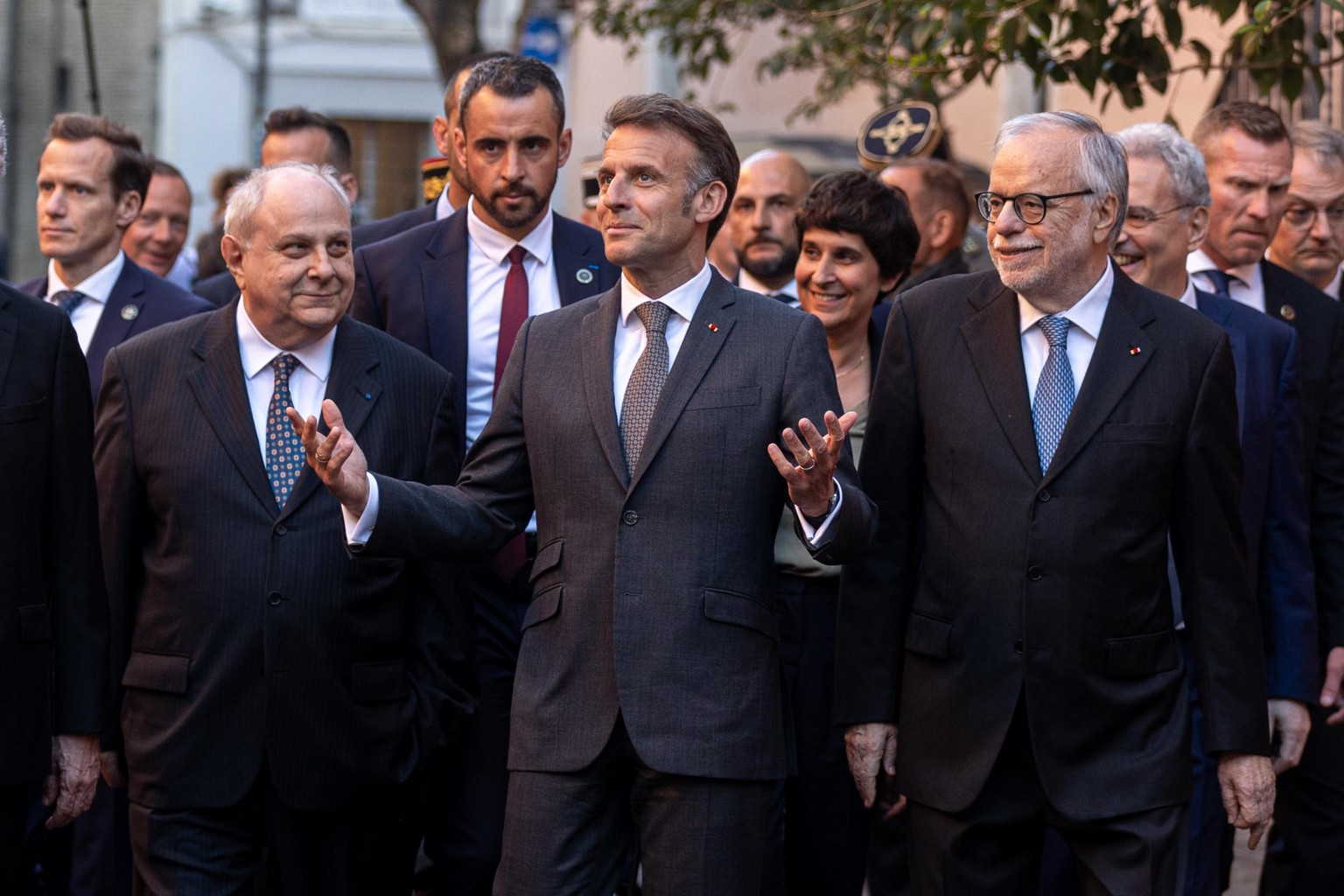 epa12878367 French President Emmanuel Macron (C) reacts as he meets with the Sant'Egidio community in Rome, Italy, 09 April 2026. During his two-day visit to Rome, President Macron will meet the  ...