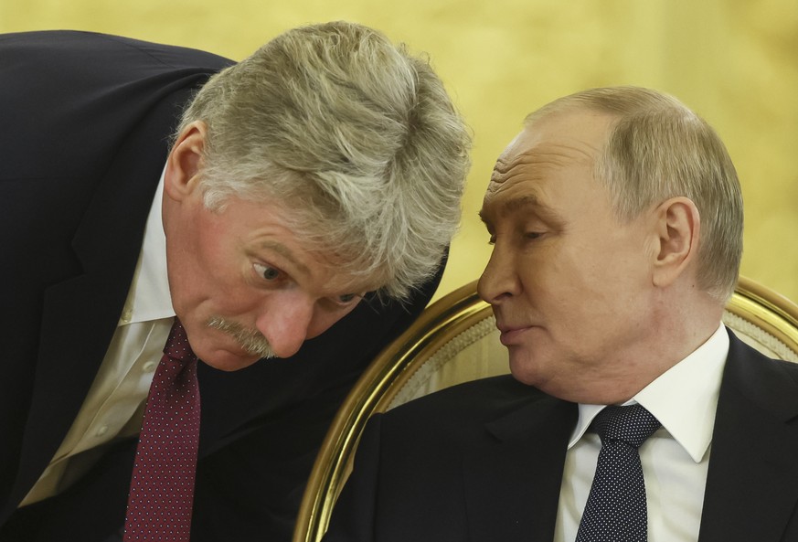 epa11649489 Russian President Vladimir Putin (R) speaks with Kremlin spokesman Dmitry Peskov during an extended meeting at the summit of the heads of state of the Commonwealth of Independent States (C ...
