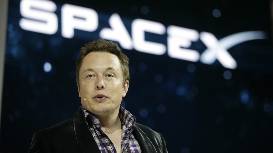 FILE - In this May 29, 2014, file photo, Elon Musk, CEO and CTO of SpaceX, introduces the SpaceX Dragon V2 spaceship at the SpaceX headquarters in Hawthorne, Calif. Musk
