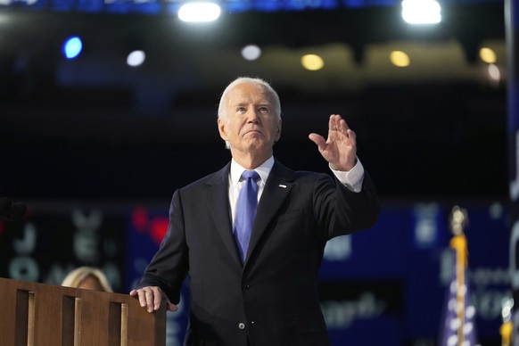 President Joe Biden waves during the Democratic National Convention Monday, Aug. 19, 2024, in Chicago. (AP Photo/Paul Sancya)