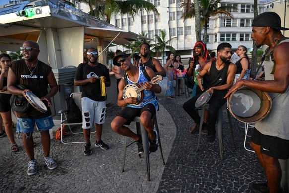 The samba group Na Rua plays at a kiosk at Arpoador beach in Rio de Janeiro, Brazil, on December 10, 2025. Rio de Janeiro is no longer crowded only for New Year's Eve or Carnival. The Brazilian c ...