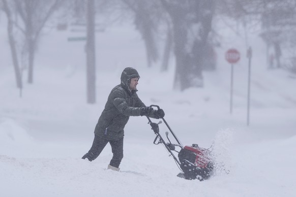 A person uses a snowblower to clear snow in Halifax on Saturday, Feb. 3, 2024. Environment Canada has issued weather alerts across Nova Scotia with predictions anywhere from 30 to 80 centimeters of sn ...